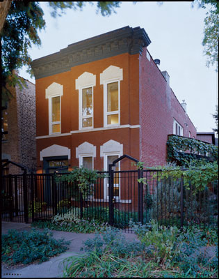 
Ray retained the historic façade of his East Village brick home and lovingly restored many of its neglected details, including the original cornice and the flower-patterned limestone window lintels. He also installed modern double-glazed casement windows and created a single front entrance and foyer. (Originally there had been two separate front doors: one for the ground-level rental unit and the other leading to the upstairs home.)
